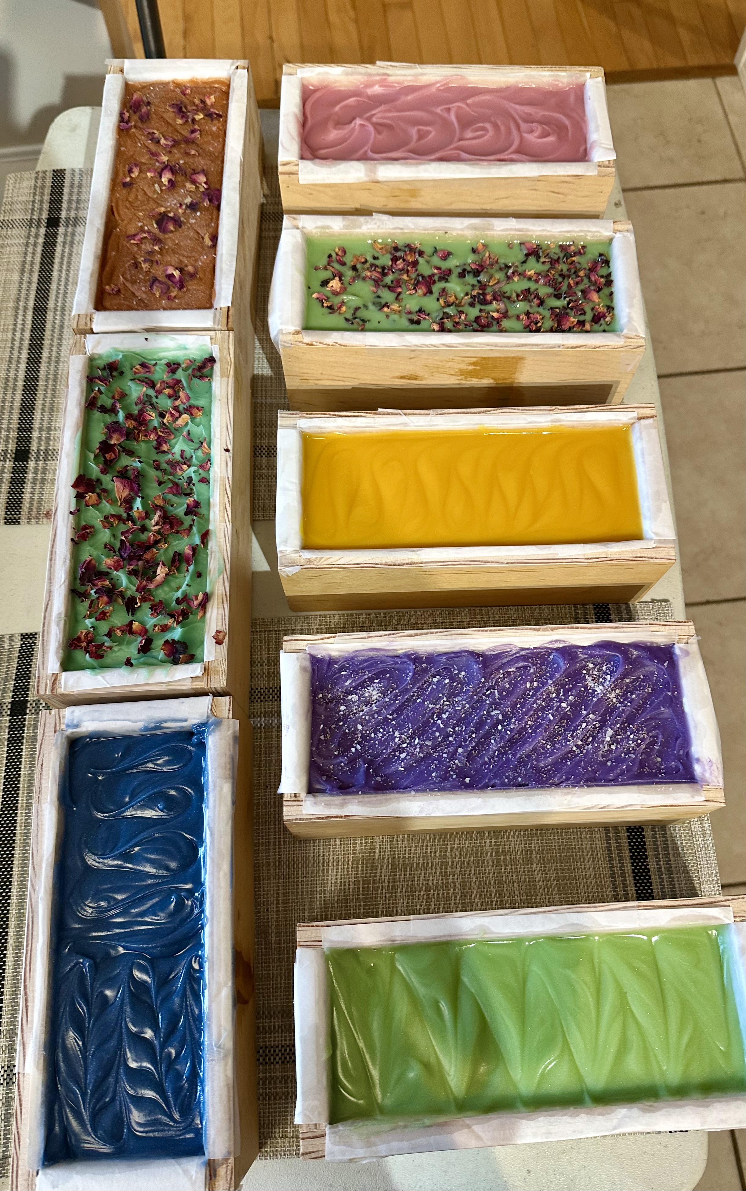 Colorful soap loaves curing in wooden molds