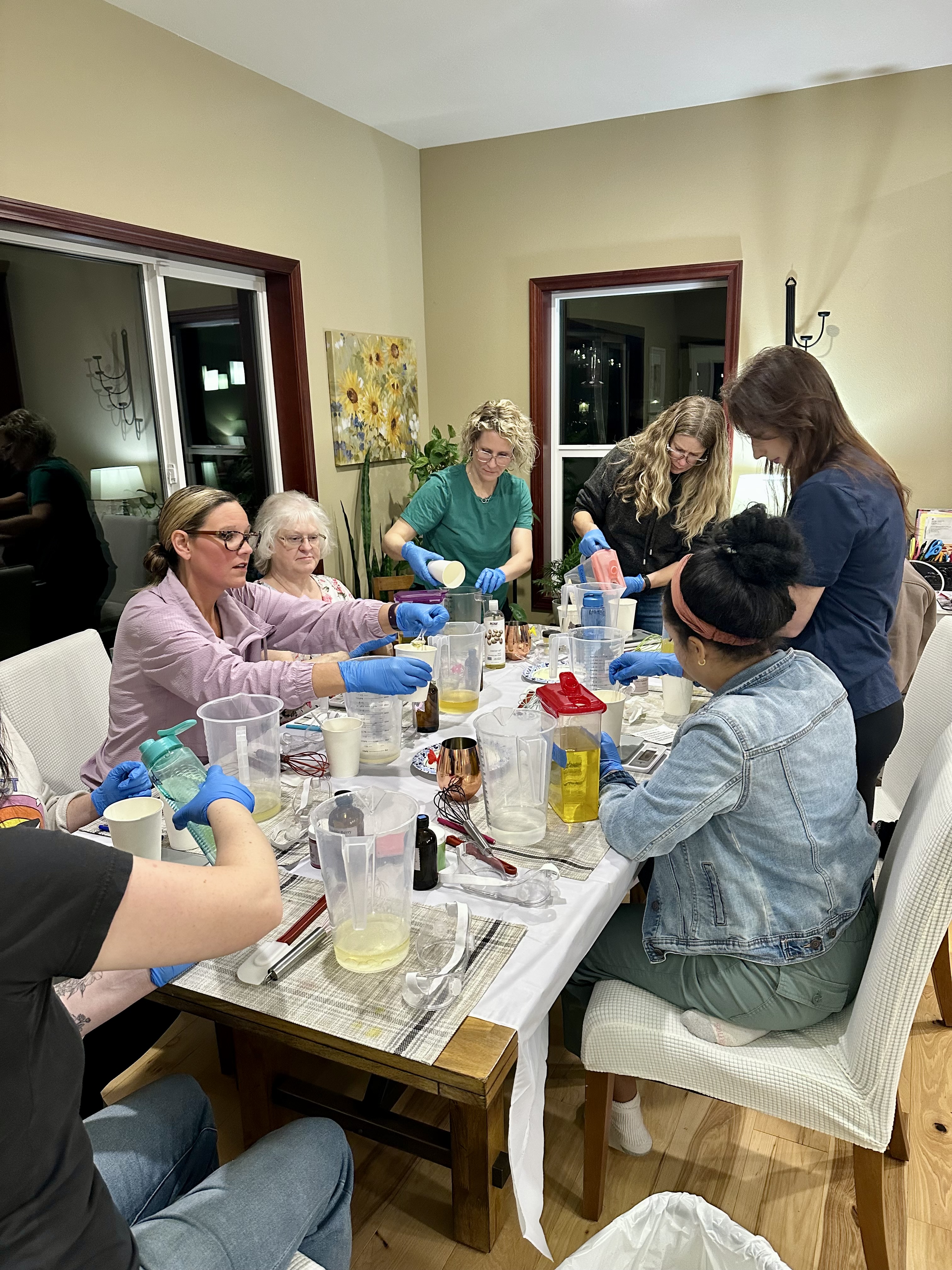 Friends making soap together at a Shell's Suds workshop